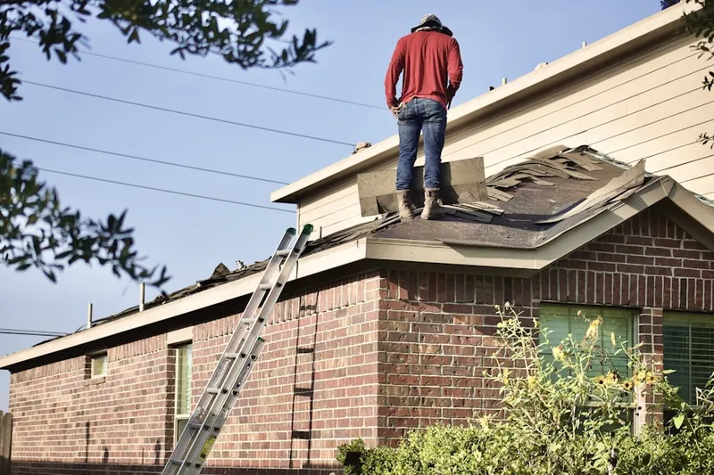 Professional roofer working on a residential roof in Creve Coeur